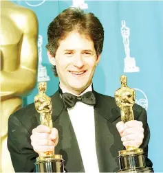  ??  ?? Horner holds his two Oscars for Best Original Song for ‘My Heart Will Go On’ and Best Dramatic Score for ‘Titanic’ at the 70th Annual Academy Awards in Los Angeles, California on Mar 23, 1998. — AFP file photo