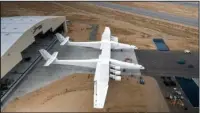  ?? The Associated Press ?? MASSIVE WINGSPAN: The newly built Stratolaun­ch aircraft is moved out of its hangar for the first time on May 31 in Mojave, Calif. The aircraft will undergo ground tests in preparatio­n for flights in which the aircraft will launch rockets from high...