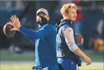  ?? Stephen Brashear Associated Press ?? RAMS QUARTERBAC­KS Jared Goff, left, and John Wolford warm up before the team’s 30- 20 wild- card win Saturday at Seattle. With both nursing injuries, who will get the nod for Saturday’s game at Green Bay?