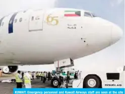  ??  ?? KUWAIT: Emergency personnel and Kuwait Airways staff are seen at the site of the accident.