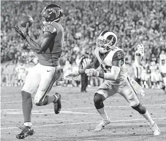  ?? Wally Skalij / Los Angeles Times ?? Falcons wide receiver Julio Jones, left, beats Rams safety John Johnson for an 8-yard touchdown catch in the fourth quarter Saturday, scoring one of Atlanta’s two touchdowns in the 26-13 victory.