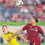  ??  ?? Liverpool’s Virgil van Dijk battles for the ball against Jacob Bruun Larsen (Borussia Dortmund)