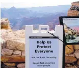  ?? MATT YORK/ASSOCIATED PRESS ?? A social distancing sign is seen at the Grand Canyon on May 15, in Grand Canyon, Arizona. Masks are not required but are highly recommende­d.