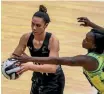  ?? GETTY IMAGES ?? Grace Rasmussen of New Zealand looks to pass under pressure from Jamaica’s Kerry-Ann Brown yesterday.