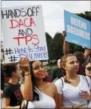  ?? ASSOCIATED PRESS ?? Yurexi Quinones, 24, of Manassas, Va., a college student who is studying social work and a recipient of Deferred Action for Childhood Arrivals, known as DACA, rallies next to Ana Rice, 18, of Manassas, Va., far right, in support of DACA, outside of the...