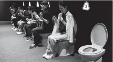  ?? Jae C. Hong / Associated Press ?? Visitors laugh as they jokingly motion to give a push while sitting on toilets at the Unko Museum in Yokohama, near Tokyo. In a country known for its cult of cute, even poop is not an exception.
