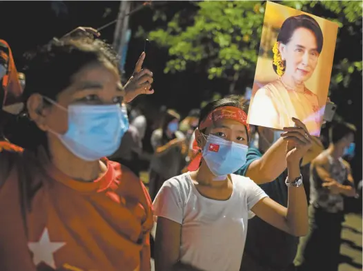  ?? Reuters / Shwe Paw Mya Tin ?? In Yangon, a supporter of the National League for Democracy holds a picture of Aung San Suu Kyi after the Myanmar general election.