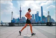  ?? YIN LIQIN / FOR CHINA DAILY ?? A man runs at the Bund in Shanghai at noon on Friday. The temperatur­e in the city reached 40.9 C, a record high.