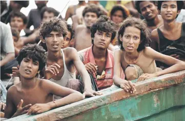  ??  ?? File photo taken on May 14, 2015 shows Rohingya migrants sitting in a boat drifting in Thai waters off the southern island of Koh Lipe in the Andaman Sea. — AFP photo