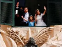  ?? DARRIN ZAMMIT LUPI / REUTERS ?? Malta’s Prime Minister Robert Abela, his wife, Lydia, and their daughter, Giorgia Mae, wave to supporters on March 28 from a window of the office of the prime minister in Valletta, Malta, after Abela’s swearing-in for another term.