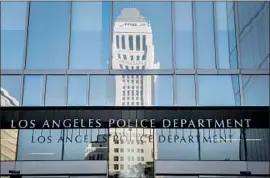  ?? Nick Agro For The Times ?? LABELING PEOPLE as gang members affects their job and housing prospects, and future dealings with police. Above, LAPD headquarte­rs ref lects City Hall.