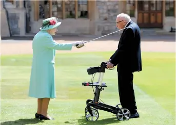  ??  ?? Britain’s Queen Elizabeth II confers the honor of knighthood on Captain Tom Moore at Windsor Castle on July 17. — Reuters