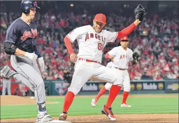  ?? Wally Skalij Los Angeles Times ?? BRADLEY ZIMMER beats Angels pitcher JC Ramirez to first base in Anaheim’s 6-0 loss at home Monday.