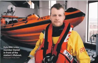  ?? Photograph: Andy Tobin. ?? Kyle RNLI crew member Daniel in front of the station’s lifeboat.