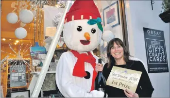  ??  ?? Winter festival mascot Coolio with Janet Macleod, whose Orsay business won last year's best-dressed window competitio­n.