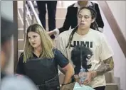  ?? Alexander Zemlianich­enko Associated Press ?? BRITTNEY GRINER wears a Jimi Hendrix shirt as she is led to a courtroom Friday in Khimki, Russia.