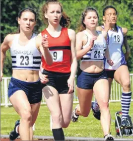  ??  ?? HEADING FOR THE LINE: Tonbridge AC’s Katie White (No.23), M&M’s Darcey Kuypers (No.9) and Tonbridge’s Rose Hairs in the under-17 200m final
