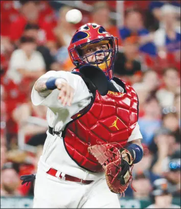  ?? TOM GANNAM / ASSOCIATED PRESS FILE (2021) ?? St. Louis Cardinals catcher Yadier Molina throws to first in a game July 16, 2021, in St. Louis. Molina has unofficial­ly been sharing managing duties for years, says Cardinals manager Oliver Marmol, who is 4 years younger than the catcher.