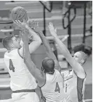  ?? Melissa Phillip / Houston Chronicle ?? HBU’s Cody Stetler, left, rises above Southeaste­rn Louisiana’s Dominic Nelson and Jordon Capps for the shot.