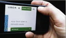  ?? KIRSTY WIGGLESWOR­TH / ASSOCIATED PRESS ?? London’s transport authority said Friday it would not renew Uber’s license to operate in the city, charging that the firm demonstrat­es a lack of corporate responsibi­lity.