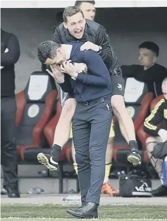  ??  ?? James Fowler jumps on the back of Jack Ross while both take charge of St Mirren last season.