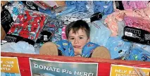  ?? PHOTO: ELEANOR WENMAN/FAIRFAX NZ ?? Hugo, 4, dived into the PJS for Hutt Kids drop-off bin at the Warehouse Petone for the official launch. He was in Hutt Hospital earlier this year.