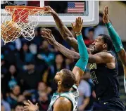  ?? MICHAEL DWYER / ASSOCIATED PRESS ?? Dewayne Dedmon (14) and Isaiah Taylor scored nine straight points for the Hawks after they trailed 103-101 with 2 minutes remaining.