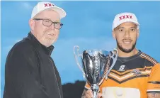  ?? ?? Southport’s Eni Folau receives the premiershi­p trophy last year. Photo: Regi Varghese