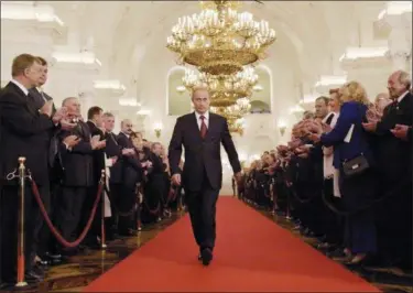  ?? ALEXANDER ZEMLIANICH­ENKO — THE ASSOCIATED PRESS FILE ?? In this file photo taken on Friday Russian President Vladimir Putin walks through St.George’s Hall to take part in an inaugurati­on ceremony in Moscow’s Kremlin, Russia. Vladimir Putin looks more invincible than ever before in his 18 years in power,...