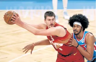  ?? Sarah Stier, Getty Images ?? Denver’s Nikola Jokic dribbles against Jarrett Allen of the Brooklyn Nets at Barclays Center on Tuesday night.