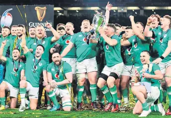  ?? — AFP photo ?? Ireland’s flanker Peter O’Mahony lifts the Six Nations trophy after winning the Six Nations internatio­nal rugby union match between Ireland and Scotland at the Aviva Stadium in Dublin.