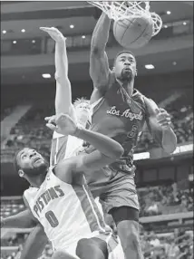  ?? Carlos Osorio Associated Press ?? CLIPPERS CENTER DeAndre Jordan dunks over Detroit’s Andre Drummond (0) and Kyle Singler in the second half.