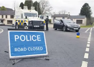  ?? PACEMAKER ?? Alert: The Newtown Road at Camlough Lake which was closed following the discovery of a suspicious object (right)