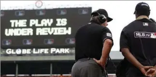  ?? ASSOCIATED PRESS FILE PHOTO ?? Major League Baseball umpires could start explaining replay decisions to the players and fans, the way National Football League referees do, later this season if the sides can reach agreement.