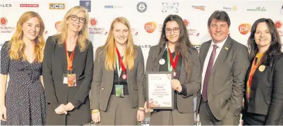  ??  ?? Pictured, Loughborou­gh High School students, Grace Johnston (centre-left) and Meeram Ibrahim (centre-right) receive The Innovation Award by Network Rail at the Big Bang Competitio­n 2018. Photo courtesy of The Big Bang Fair.