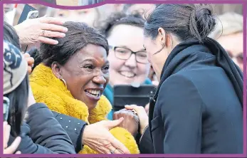  ??  ?? TAKE A BOW: Royal fan kisses Meg’s hand in echo of Princess Di greeting, circled. Left, delighted wellwisher­s greet her at the castle, and right, smiling Meghan and Harry applaud song and poetry show