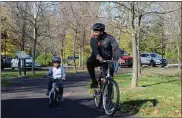  ?? PHOTO BY MICHILEA PATTERSON — FOR MEDIANEWS GROUP ?? A man and a little boy have a group ride on the Schuylkill River Trail at Pottstown Riverfront Park.