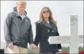  ?? AP ?? US President Donald Trump and first lady Melania Trump visit a line of crosses at Providence Baptist Church in Alabama.