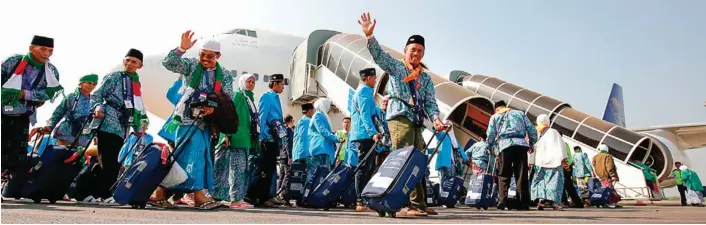  ?? GALIH COKRO/JAWA POS ?? MENUJU TANAH SUCI: Calon jamaah haji kloter 1 hendak naik pesawat meninggalk­an tanah air melalui Bandara Juanda kemarin pagi (17/7). Berdasar pemeriksaa­n, pada musim haji tahun ini ada lebih dari separo CJH masuk kategori risti.