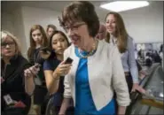  ?? J. SCOTT APPLEWHITE — THE ASSOCIATED PRESS ?? Sen. Susan Collins, R-Maine is surrounded by reporters as she heads to the Senate on Capitol Hill in Washington, Thursday, July 27, 2017, while the Republican majority in Congress remains stymied by their inability to fulfill their political promise to...