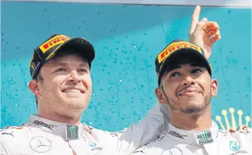  ?? EPA ?? Nico Rosberg of Mercedes, left, and teammate Lewis Hamilton celebrate on the podium after the Belgium Grand Prix.