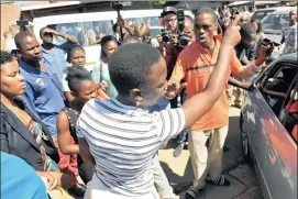  ?? Picture: Antoine de Ras ?? TENSE: A woman shouts at friends and relatives of the woman accused of killing rapper Nkululeko ‘Flabba’ Habedi outside the Alexandra Magistrate’s Court yesterday.