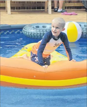  ?? NANCY KING/CAPE BRETON POST ?? Nine-year-old Harland Fraser of New Waterford tries out his new backyard pool for the first time Friday. The Fraser family had a pool party to celebrate the granting of Harland’s wish by the Children’s Wish Foundation.