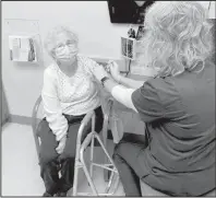  ??  ?? Val Storbeck (right), LPN, Vax Champ at Sanford, administer­s a COVID vaccine to Donna Walker, a Sanford Clinic patient.