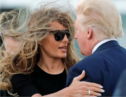  ??  ?? Blown it: Melania Trump’s hair suffers at the windswept Andrews Air Force Base, while Donald’s seems unaffected