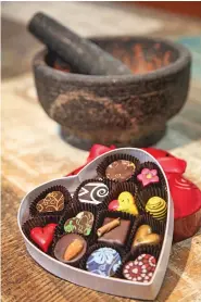  ??  ?? ABOVE: A heart-shaped box full of chocolate at Art of Chocolate/Cacao Santa Fe.