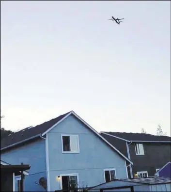  ?? The Associated Press ?? A photo taken from video provided by Courtney Junka shows the stolen Horizon Air turboprop plane flying Friday over Eatonville, Wash.