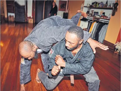  ?? ?? Actor Jamie Hector, right, practises his martial arts moves at a dojo in Brooklyn, New York.