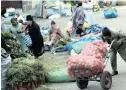  ??  ?? A MAN brings onions to a street market in La Paz, Bolivia. A health audit of market produce found that most of it was unacceptab­le, due to waste water irrigating the fields the produce grew in.