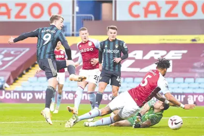  ?? - AFP photo ?? Leeds United's English striker Patrick Bamford (L) scores the opening goal against Aston Villa during the football match at Villa Park in Birmingham.